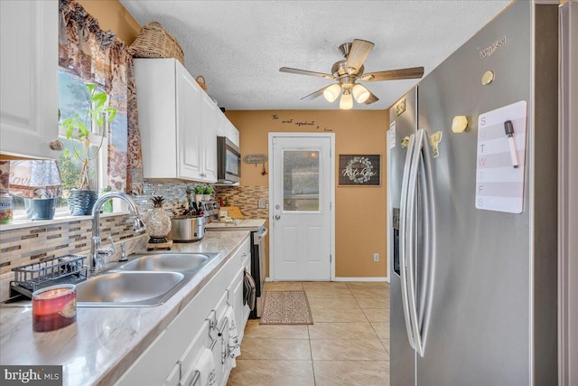 859 Columbia Ave, Newfield, NJ 08344 - kitchen with stainless steel appliances, light countertops, tasteful backsplash, healthy amount of natural light, and a textured ceiling