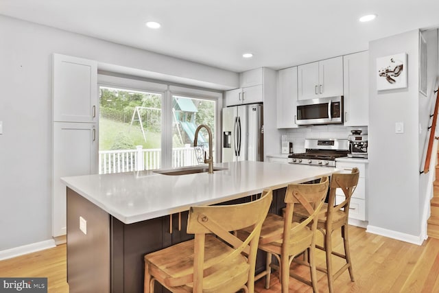 11106 Byrd Dr, Fairfax, VA 22030 - kitchen featuring stainless steel appliances, a sink, light wood finished floors, white cabinetry, and recessed lighting