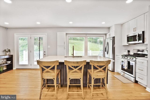 11106 Byrd Dr, Fairfax, VA 22030 - kitchen featuring stainless steel appliances, a sink, light wood-type flooring, light countertops, and recessed lighting
