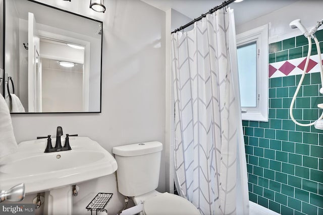 11106 Byrd Dr, Fairfax, VA 22030 - full bath with tile walls, toilet, tiled shower, and a sink