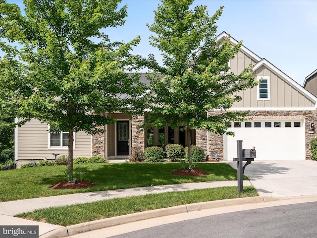 130 Grosbeak Ct, Lake Frederick, VA 22630 - obstructed view of property featuring stone siding, concrete driveway, board and batten siding, a garage, and a front yard
