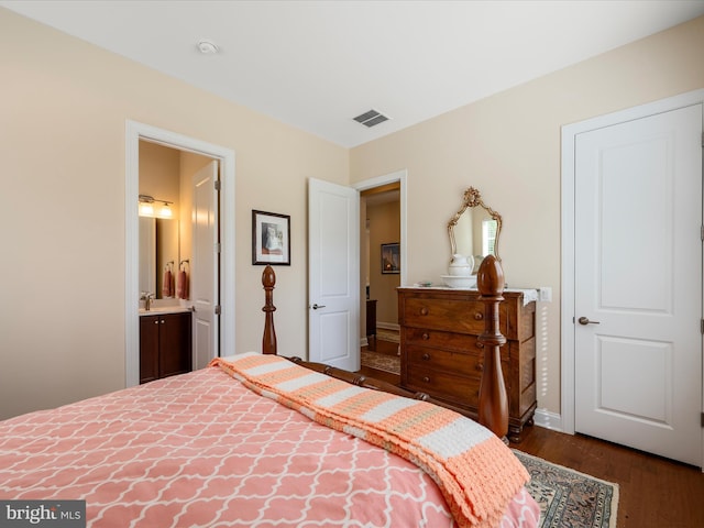 130 Grosbeak Ct, Lake Frederick, VA 22630 - bedroom featuring dark wood-style floors, a sink, ensuite bathroom, and baseboards