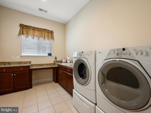 130 Grosbeak Ct, Lake Frederick, VA 22630 - laundry room featuring independent washer and dryer, cabinet space, and light tile patterned floors