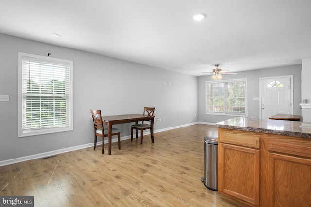 94 Gary Ln, Front Royal, VA 22630 - kitchen featuring light wood-style floors, ceiling fan, baseboards, and brown cabinetry