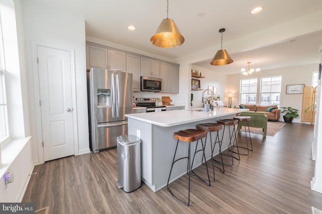 30 Kirby Ct, Bunker Hill, WV 25413 - kitchen featuring stainless steel appliances, gray cabinets, wood finished floors, light countertops, and a chandelier