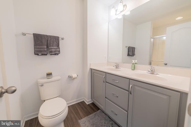 30 Kirby Ct, Bunker Hill, WV 25413 - full bathroom with wood finished floors, double vanity, toilet, baseboards, and an enclosed shower