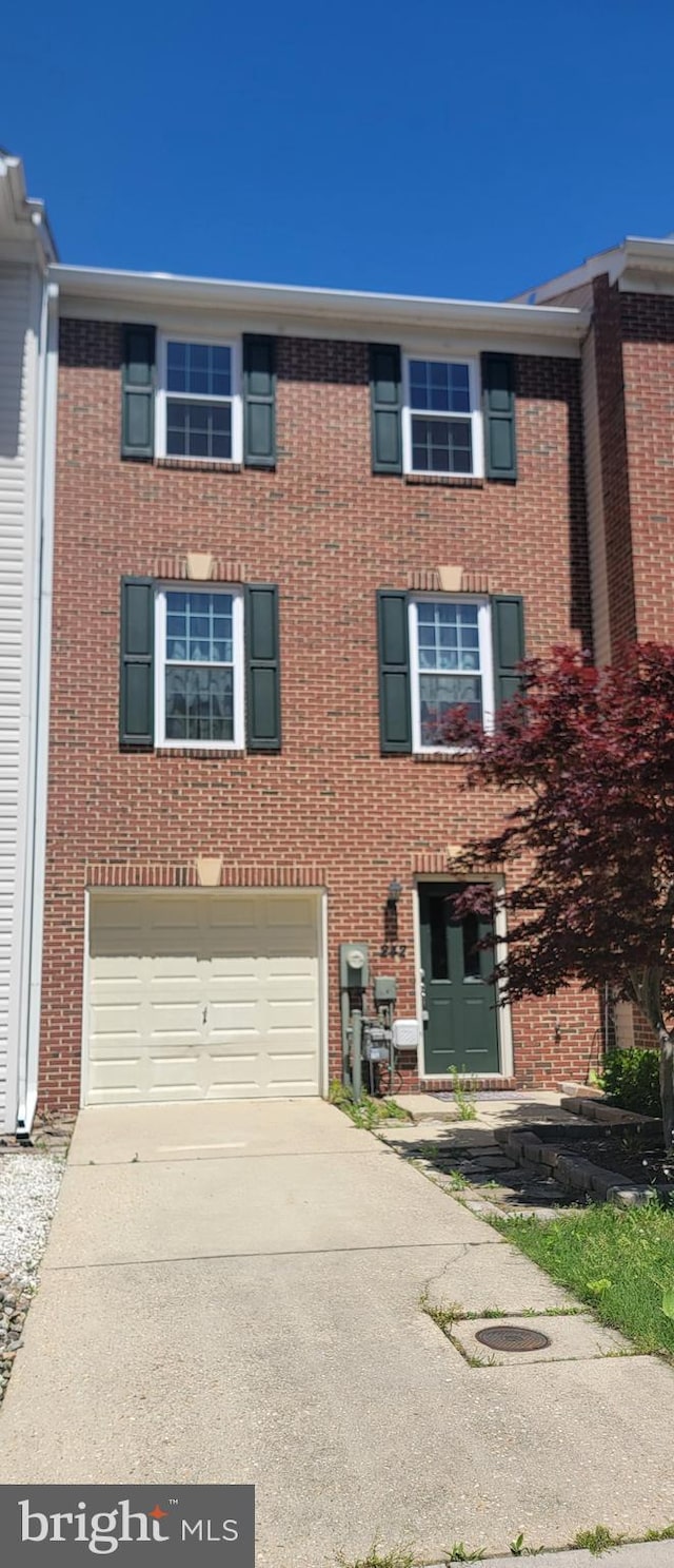 242 Tilden Way Unit 7242, Edgewater, MD 21037 - view of property featuring an attached garage, concrete driveway, and brick siding