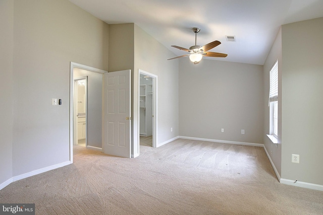 242 Tilden Way Unit 7242, Edgewater, MD 21037 - unfurnished bedroom featuring light colored carpet, a walk in closet, a closet, high vaulted ceiling, and a ceiling fan