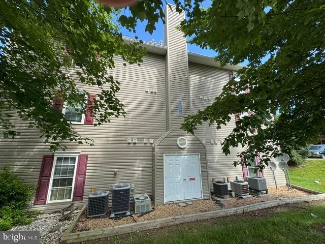 106 Timberlake Ter Unit 10, Stephens City, VA 22655 - back of house featuring central AC and a chimney