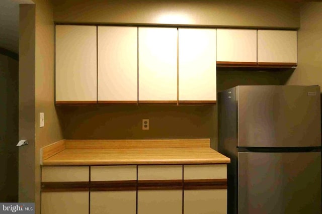 1647 Carriage House Ter Unit 1647-C, Silver Spring, MD 20904 - detailed view of freestanding refrigerator, white cabinets, and light countertops