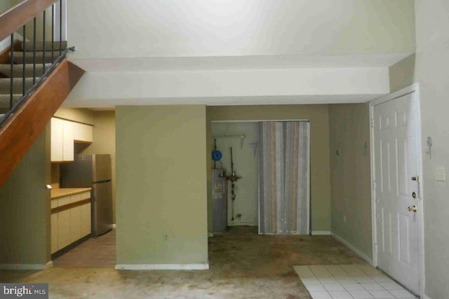 1647 Carriage House Ter Unit 1647-C, Silver Spring, MD 20904 - foyer with water heater, stairway, and baseboards