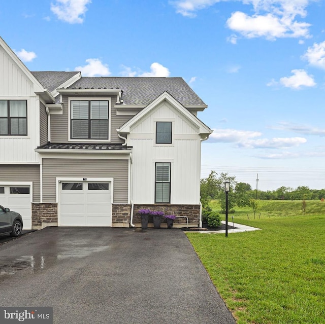 71 Tamarack Cir, Eagleville, PA 19403 - view of front of home featuring stone siding, a front yard, driveway, and a garage