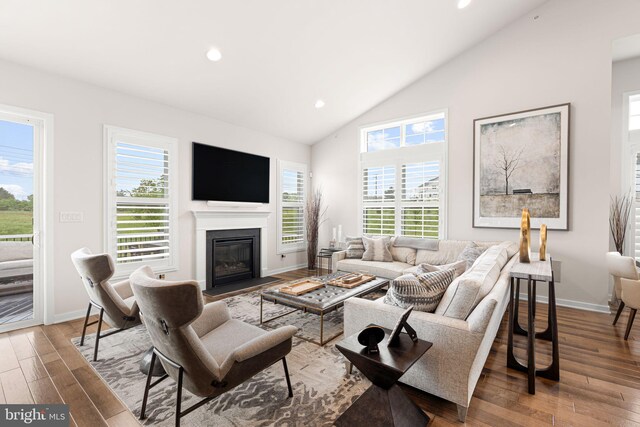 71 Tamarack Cir, Eagleville, PA 19403 - living area featuring a fireplace with flush hearth, wood finished floors, recessed lighting, baseboards, and high vaulted ceiling