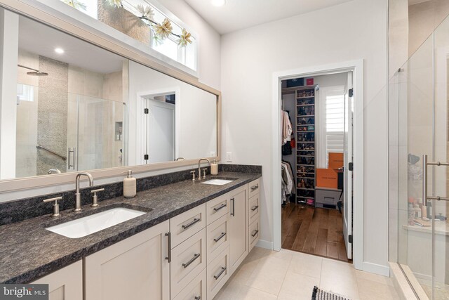 71 Tamarack Cir, Eagleville, PA 19403 - full bathroom featuring a stall shower, a walk in closet, double vanity, plenty of natural light, and recessed lighting
