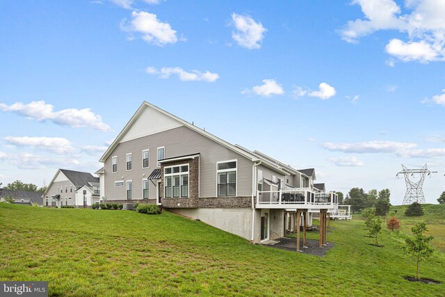 71 Tamarack Cir, Eagleville, PA 19403 - rear view of property with a yard, a wooden deck, and stone siding