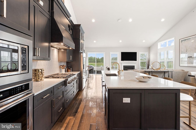 71 Tamarack Cir, Eagleville, PA 19403 - kitchen with stainless steel appliances, open floor plan, a breakfast bar area, a sink, and a kitchen island with sink
