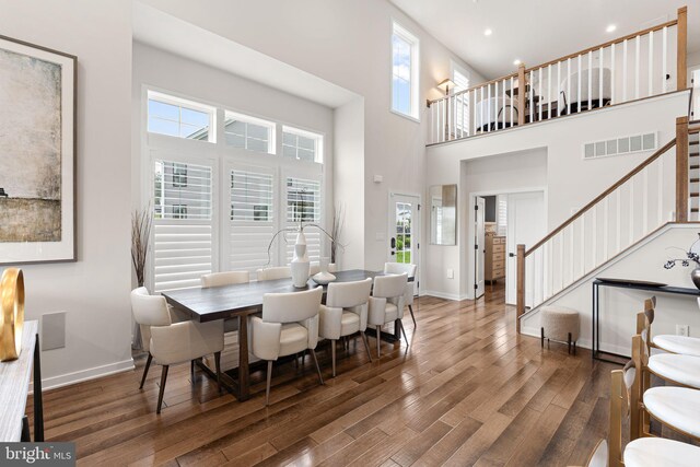 71 Tamarack Cir, Eagleville, PA 19403 - dining area with stairs, wood finished floors, baseboards, recessed lighting, and a towering ceiling