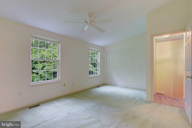 2566 Log Mill Ct, Crofton, MD 21114 - unfurnished bedroom with carpet floors, multiple windows, a closet, vaulted ceiling, and baseboards