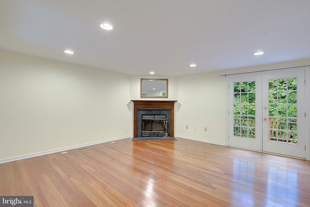 2566 Log Mill Ct, Crofton, MD 21114 - unfurnished living room with light wood finished floors, recessed lighting, a fireplace, baseboards, and french doors
