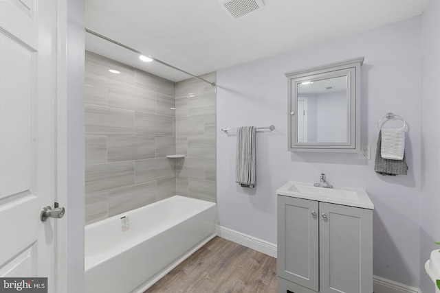 1508 W 36th St W, Baltimore, MD 21211 - full bath with wood finished floors, vanity, and bathing tub / shower combination