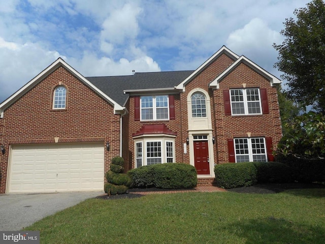 12116 Elmwood Dr, Brandywine, MD 20613 - view of front of property with driveway, brick siding, a front yard, and roof with shingles