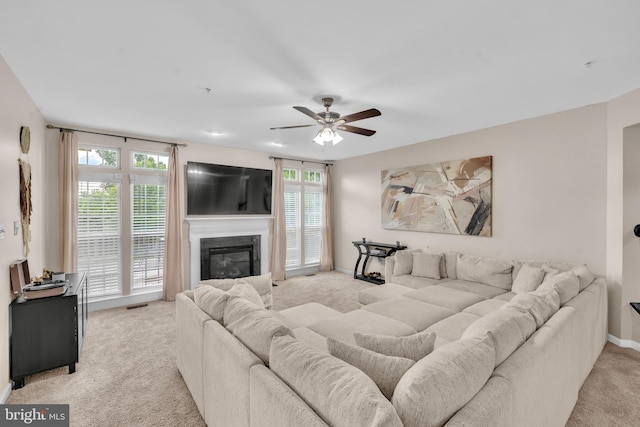 12116 Elmwood Dr, Brandywine, MD 20613 - living area with light carpet, ceiling fan, healthy amount of natural light, and a premium fireplace
