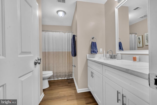 12116 Elmwood Dr, Brandywine, MD 20613 - full bath with toilet, vanity, wood finished floors, baseboards, and curtained shower