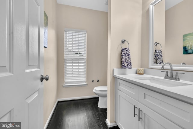 12116 Elmwood Dr, Brandywine, MD 20613 - bathroom featuring toilet, vanity, wood finished floors, and baseboards