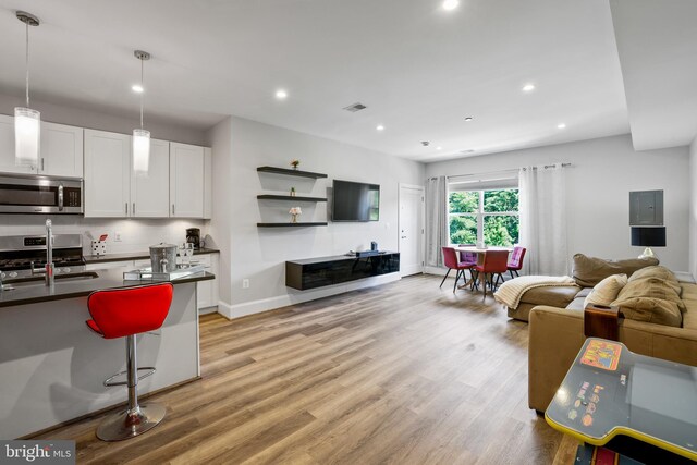 2221 M St NE Unit Ph1, Washington, DC 20002 - living room featuring light wood-style floors, recessed lighting, and baseboards