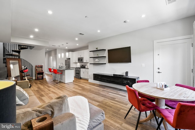 2221 M St NE Unit Ph1, Washington, DC 20002 - living area featuring stairway, light wood-style flooring, recessed lighting, and baseboards