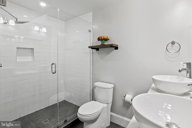 2221 M St NE Unit Ph1, Washington, DC 20002 - full bath with baseboards, a shower stall, toilet, and dual sinks