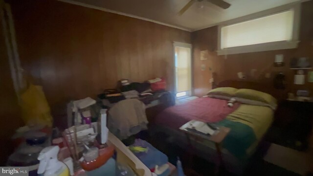 619 Sewall Ave, Asbury Park, NJ 07712 - bedroom featuring multiple windows, wood walls, and a ceiling fan