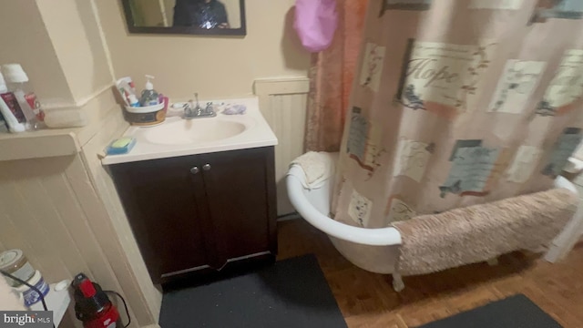 619 Sewall Ave, Asbury Park, NJ 07712 - bathroom featuring vanity, a freestanding bath, wood finished floors, and a shower with curtain