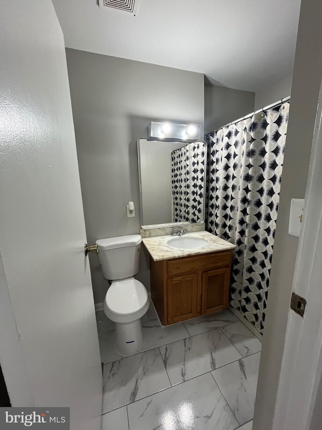 120 N Baylor Dr, Sterling, VA 20164 - bathroom featuring toilet, vanity, and marble finish floors