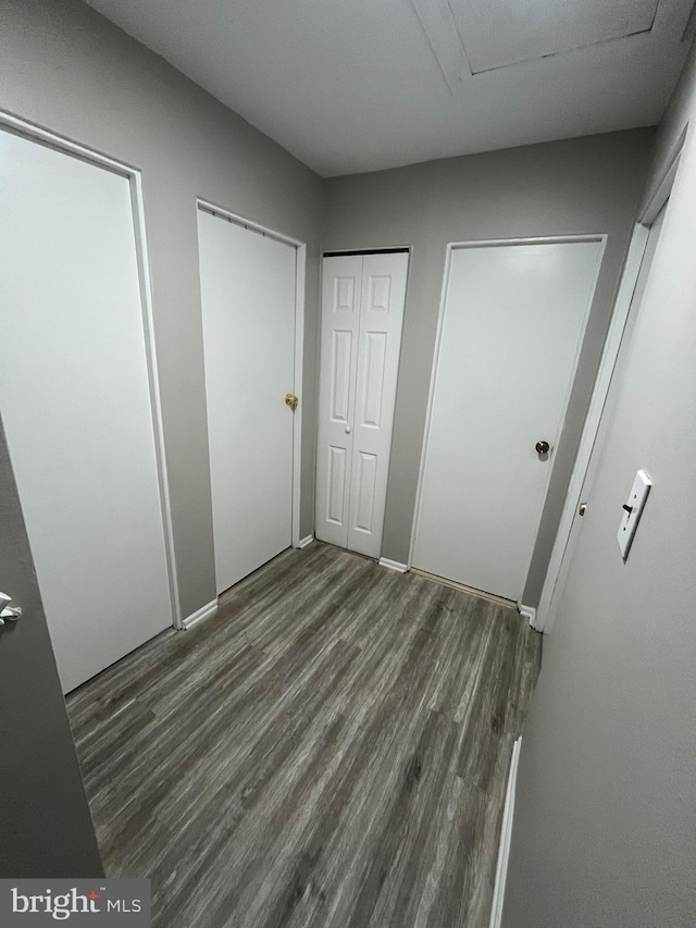 120 N Baylor Dr, Sterling, VA 20164 - unfurnished bedroom featuring wood finished floors, two closets, and attic access