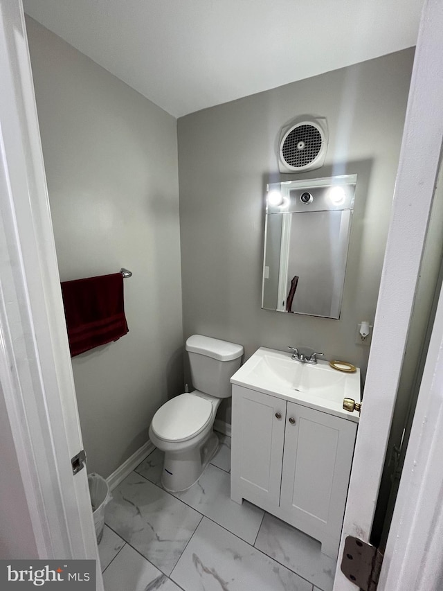 120 N Baylor Dr, Sterling, VA 20164 - half bath featuring toilet, vanity, marble look tiles, and baseboards