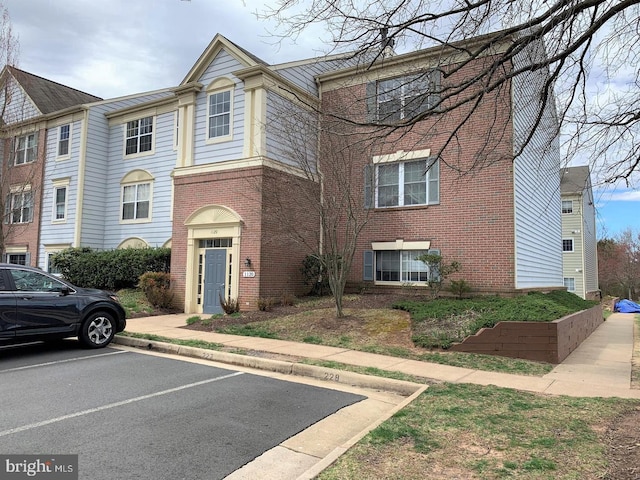 1120 Huntmaster Ter NE Unit 101, Leesburg, VA 20176 - view of property featuring brick siding and uncovered parking