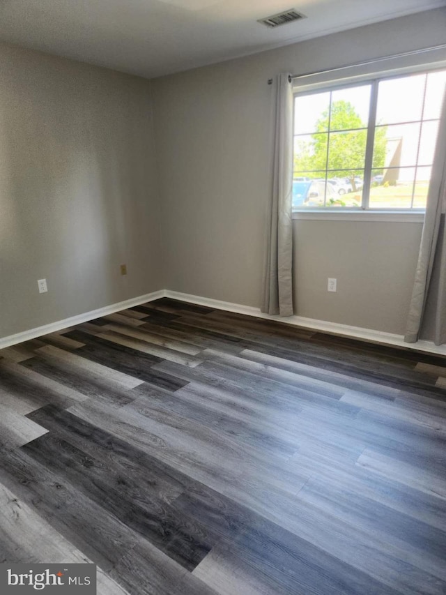1120 Huntmaster Ter NE Unit 101, Leesburg, VA 20176 - empty room featuring dark wood-style flooring and baseboards