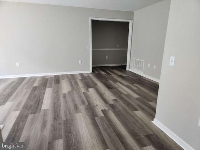 1120 Huntmaster Ter NE Unit 101, Leesburg, VA 20176 - empty room featuring dark wood-style floors and baseboards