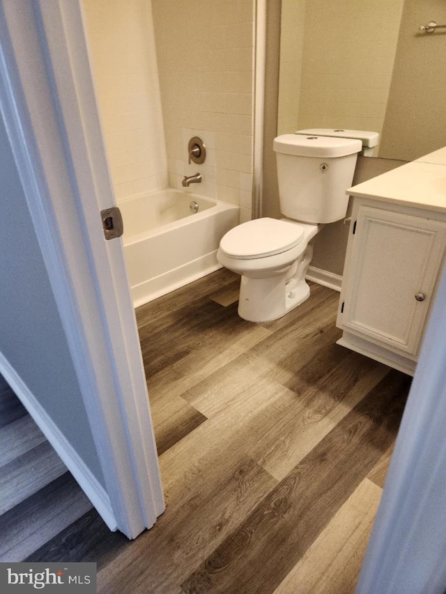 1120 Huntmaster Ter NE Unit 101, Leesburg, VA 20176 - bathroom with wood finished floors, vanity, toilet, shower / bathtub combination, and baseboards