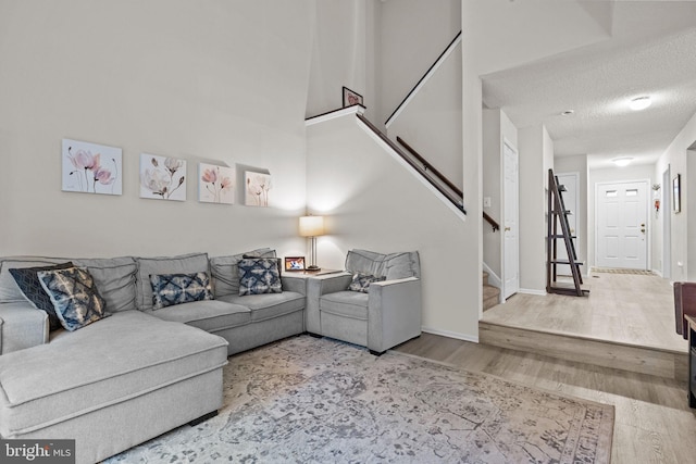 74 Haverford Ct, Hillsborough, NJ 08844 - living area featuring wood finished floors, stairway, a textured ceiling, and baseboards