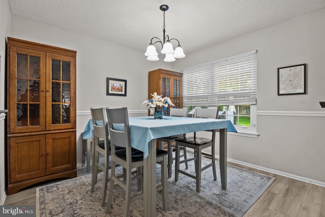 74 Haverford Ct, Hillsborough, NJ 08844 - dining area featuring a chandelier, a textured ceiling, light wood finished floors, and baseboards