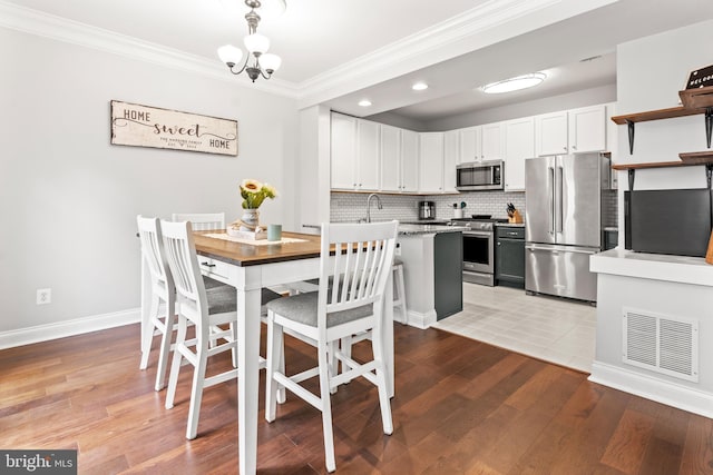 2738 Fresh Water Way, Odenton, MD 21113 - dining space with ornamental molding, recessed lighting, a chandelier, light wood-style flooring, and baseboards