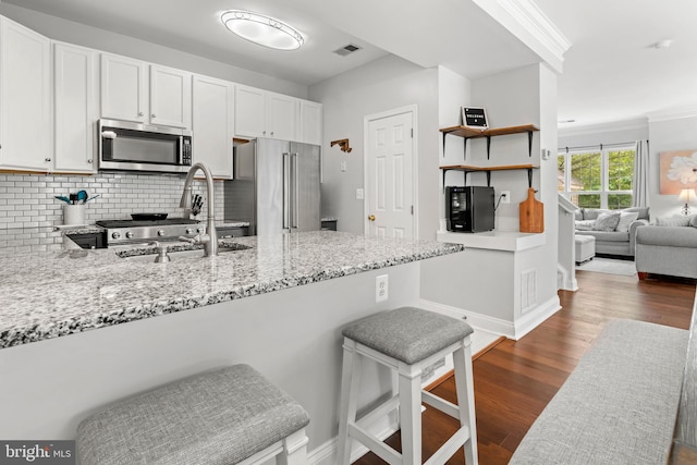 2738 Fresh Water Way, Odenton, MD 21113 - kitchen with appliances with stainless steel finishes, light stone countertops, white cabinets, decorative backsplash, and a peninsula