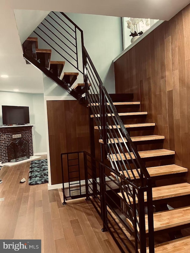 123 Bryn Mawr Ave, Bala Cynwyd, PA 19004 - staircase featuring wood finished floors and a brick fireplace