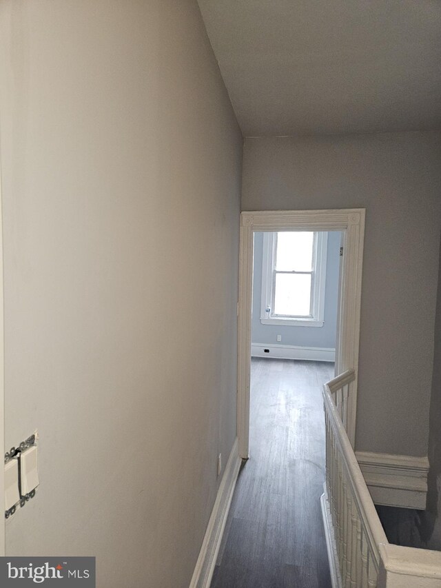 2549 N 29th St, Philadelphia, PA 19132 - corridor with dark wood-type flooring, baseboards, and an upstairs landing