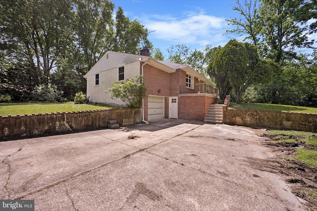 2055 Wharton Ave, Marcus Hook, PA 19061 - view of side of property with brick siding, stairs, driveway, a chimney, and a garage