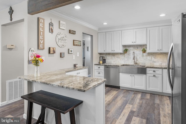 2 Gloucester Ct, Bordentown, NJ 08505 - kitchen with appliances with stainless steel finishes, a sink, dark wood-style floors, crown molding, and backsplash
