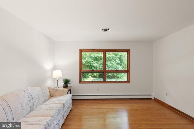 1906 Parkvue Rd, Fallston, MD 21047 - living area with light wood finished floors and a baseboard heating unit
