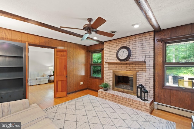1906 Parkvue Rd, Fallston, MD 21047 - unfurnished living room with wooden walls, beam ceiling, healthy amount of natural light, baseboard heating, and a ceiling fan